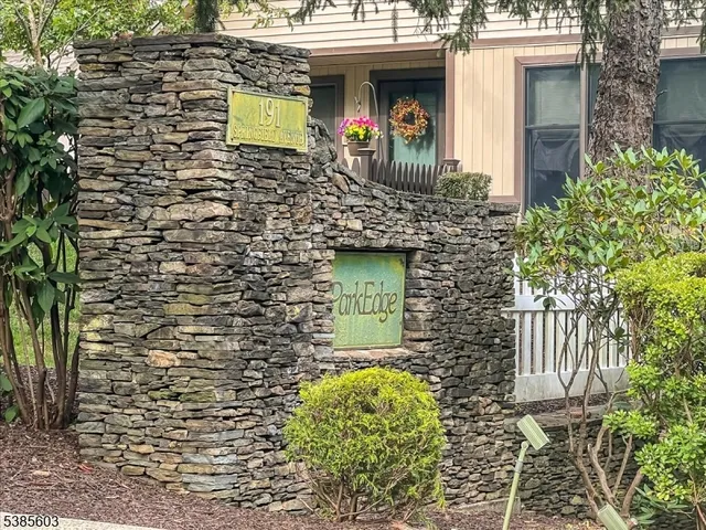 a view of a brick house with large windows