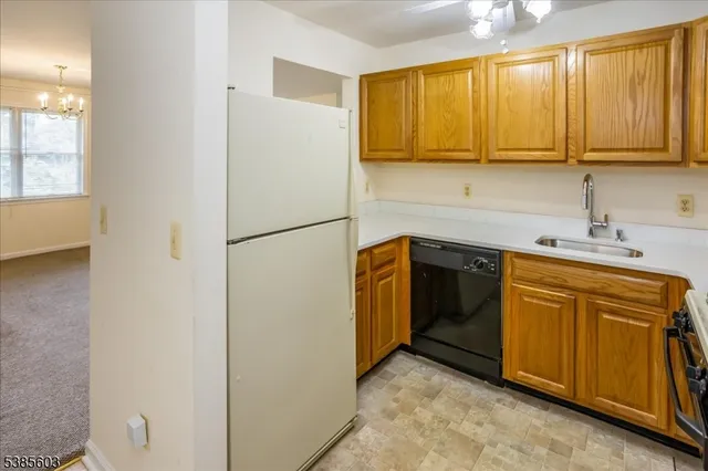 a kitchen with a refrigerator sink and cabinets