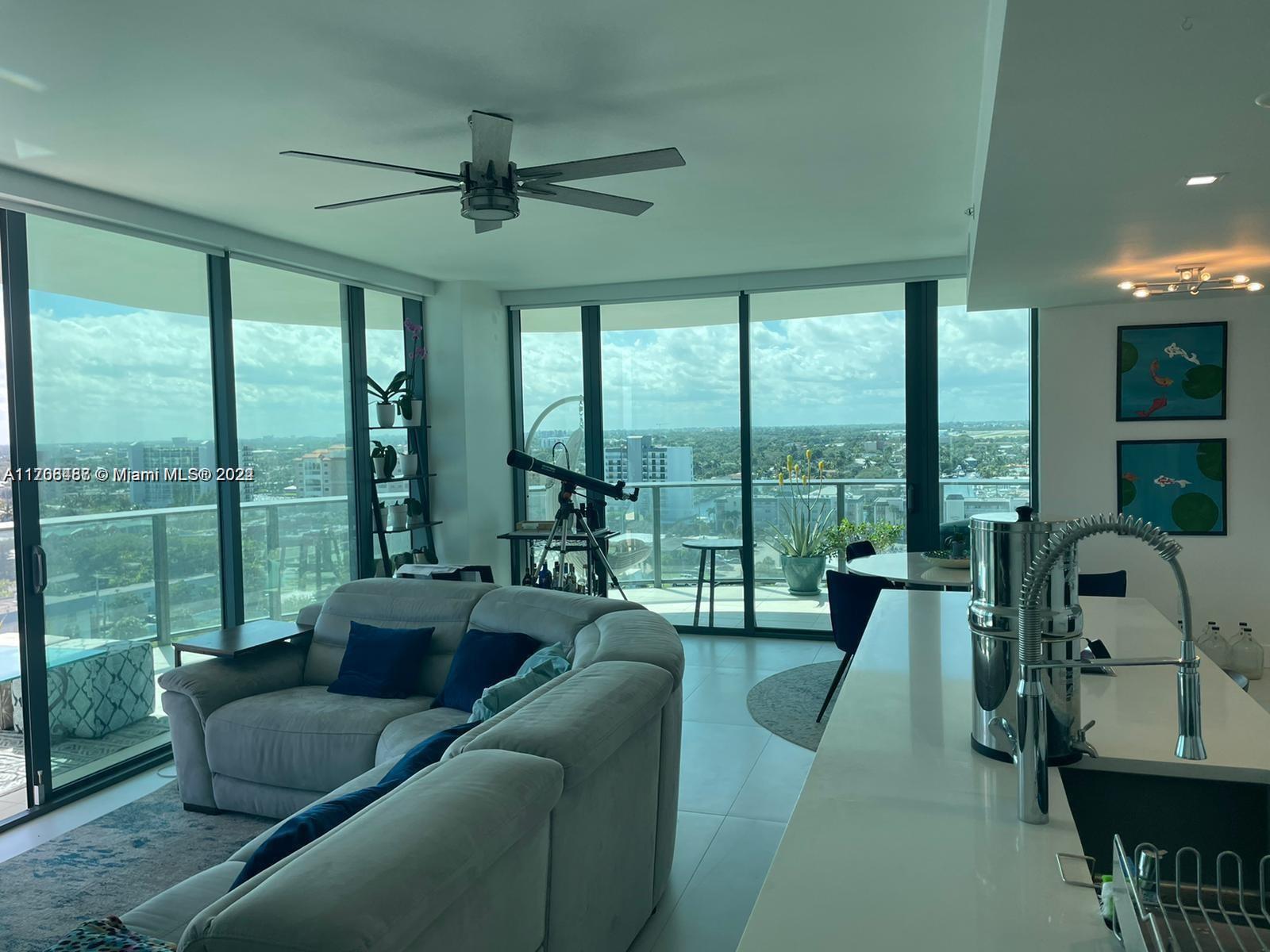 730 North Ocean Boulevard, Unit 1205 Pompano Beach, FL 33062 - Photo 8 of 19 a living room with furniture and a large window