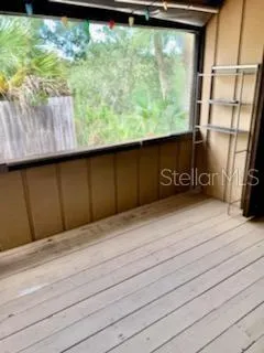a view of a closet area with wooden floor