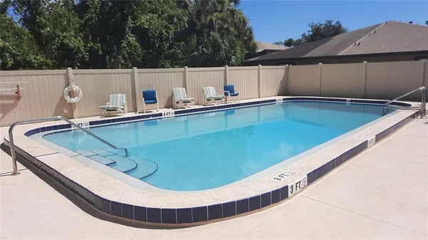 a view of a backyard with a tub and chair