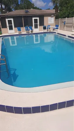 a view of a swimming pool with seating space