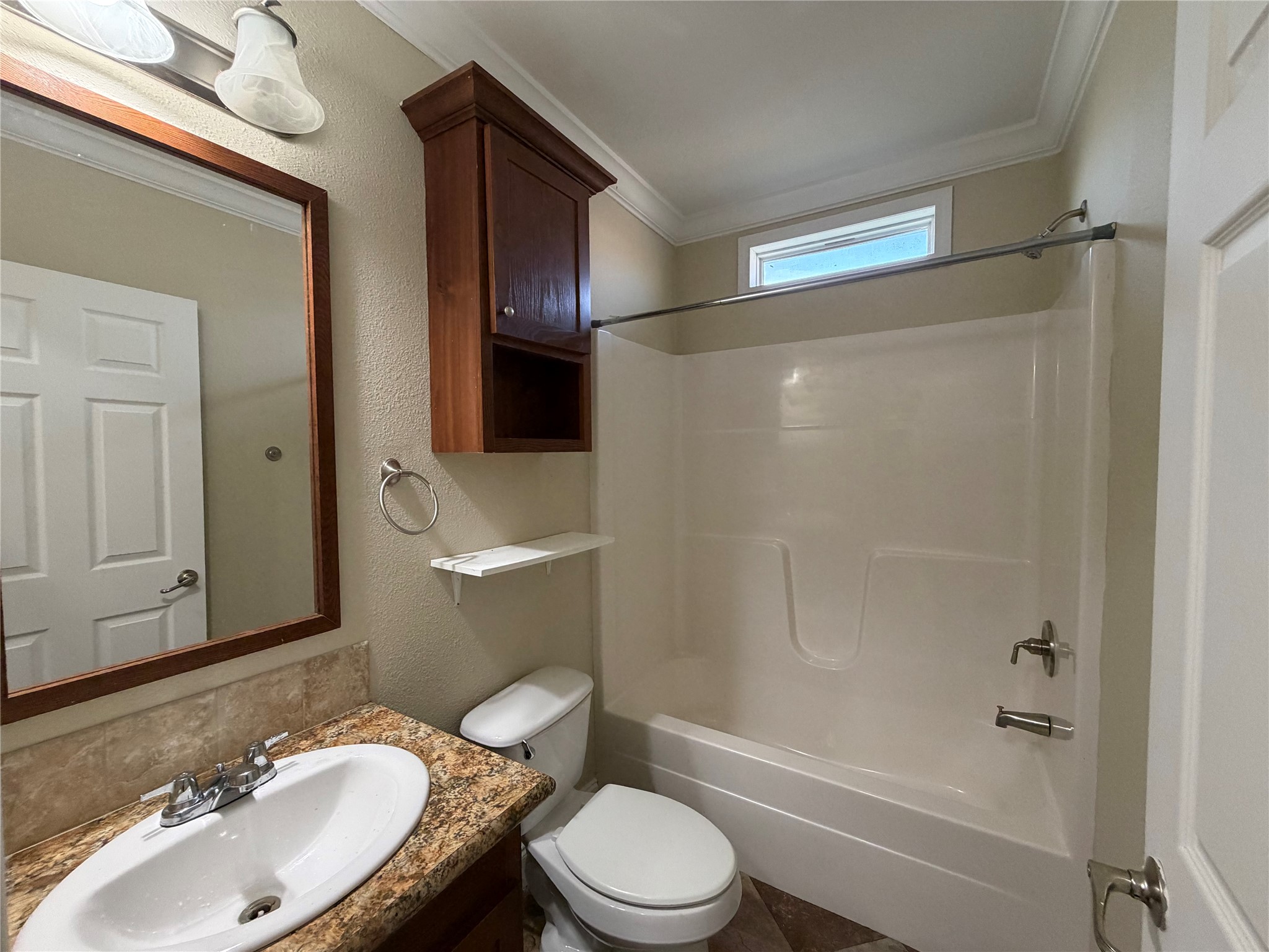 13021 Dessau Road, Unit 393 Austin, TX 78754 - Photo 9 of 10 Crisp white crown molding trims this bathroom featuring a granite vanity and tiled tub surround.