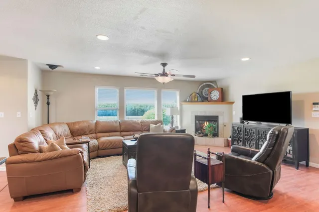 a living room with furniture a fireplace and a flat screen tv