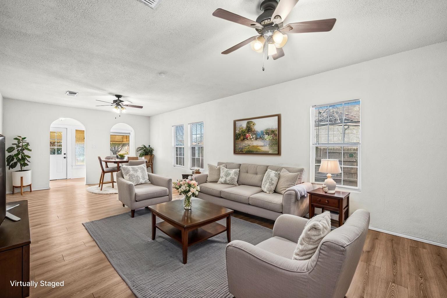 620 South 11th Street Slaton, TX 79364 - Photo 5 of 22 a living room with furniture and a wooden floor