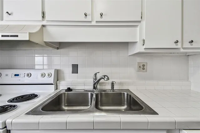a kitchen with a refrigerator stove and cabinets