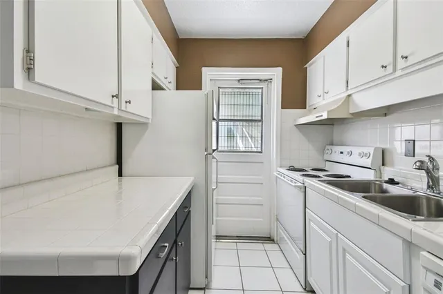 a kitchen with a refrigerator and window