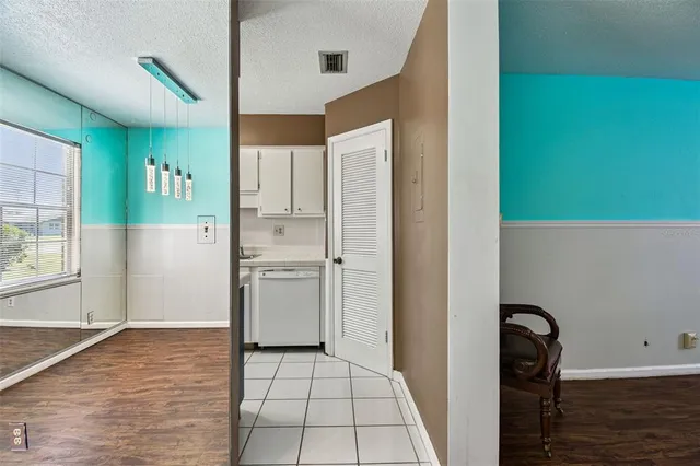 a kitchen with a refrigerator sink and cabinets
