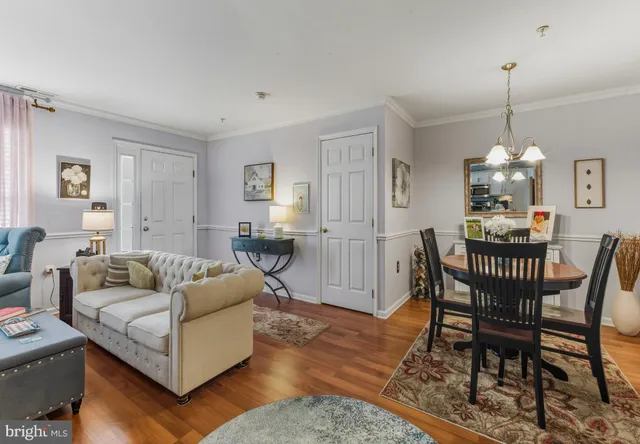 a living room with furniture wooden floor and dining table