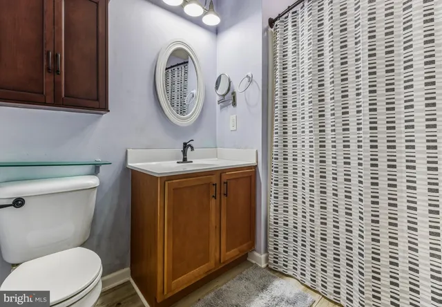 a bathroom with a toilet a sink and a mirror