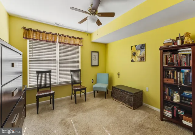 a reading room with furniture and book shelf