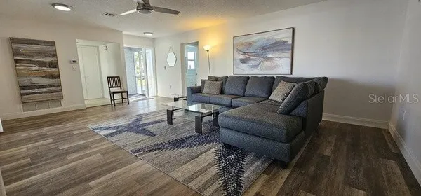 a living room with furniture and wooden floor