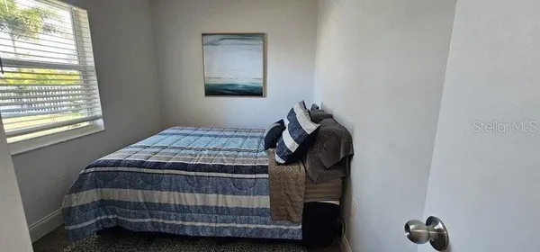a bedroom with a bed and a window