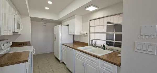 a kitchen with a sink stove and refrigerator