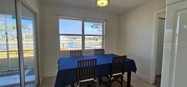 a view of a dining room with furniture and a window