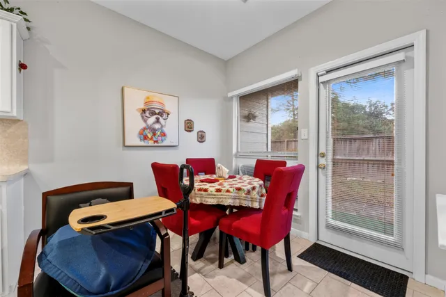 a view of a dining room with furniture a rug and wooden floor
