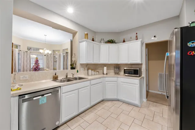 a kitchen with a sink cabinets and stainless steel appliances