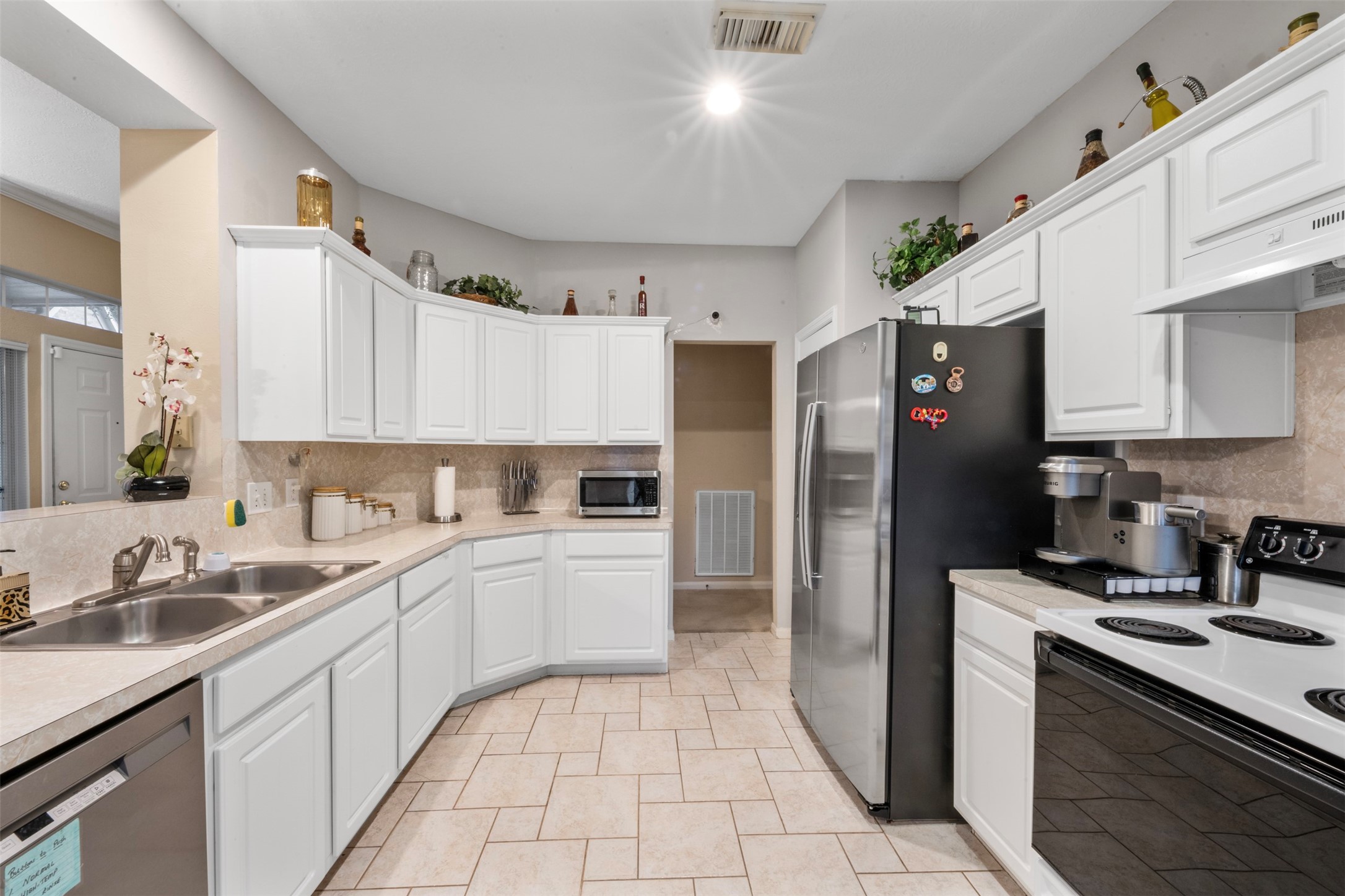 2334 Everest Way Houston, TX 77339 - Photo 15 of 29 a kitchen with a sink a refrigerator and cabinets