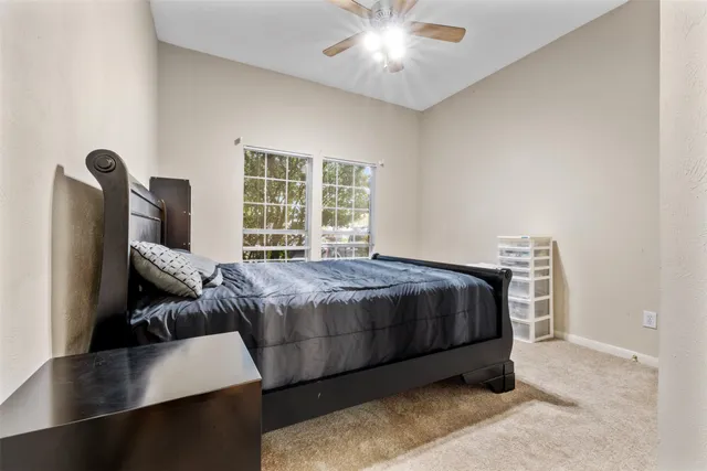 a spacious bedroom with a bed and a chandelier