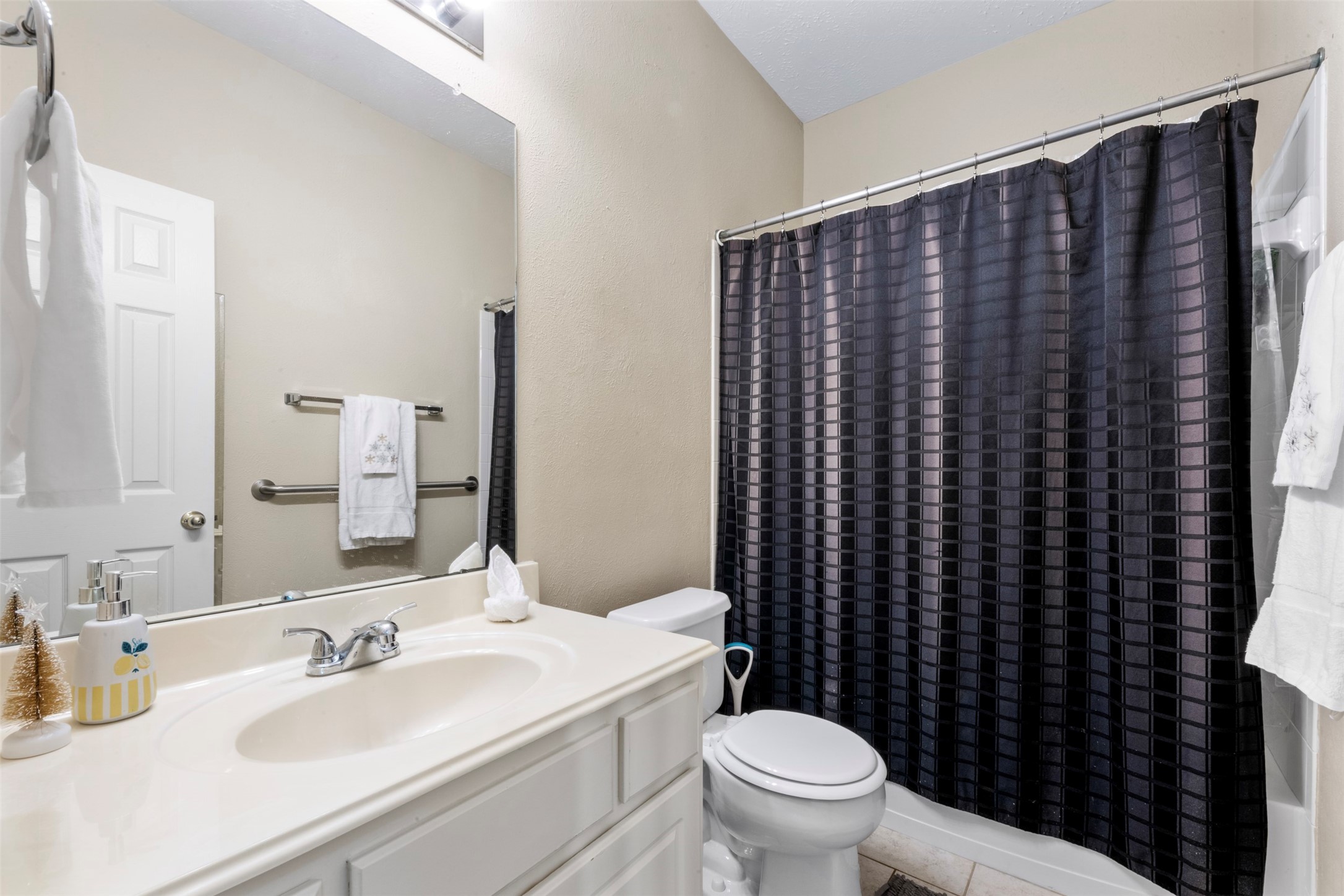 2334 Everest Way Houston, TX 77339 - Photo 19 of 29 a bathroom with a sink a toilet a mirror and shower curtain