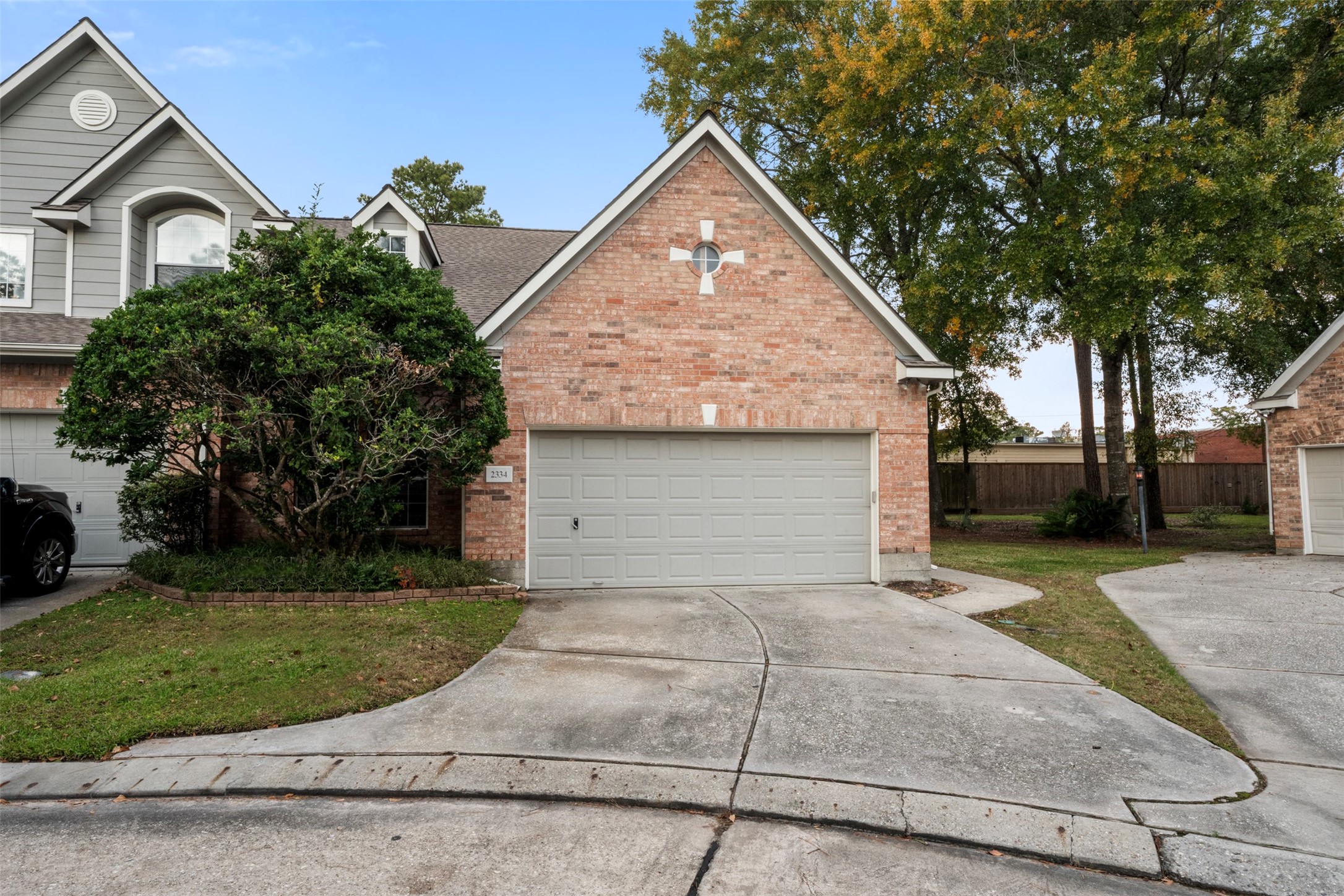 2334 Everest Way Houston, TX 77339 - Photo 28 of 29 a front view of a house with a garden and trees