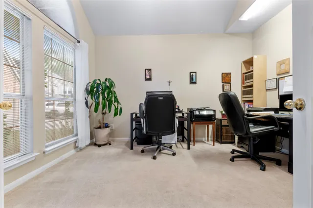 a view of a workspace with furniture and a window