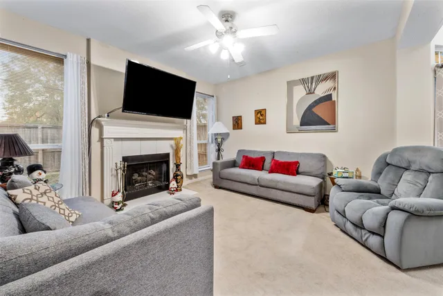 a living room with furniture a flat screen tv and a fireplace