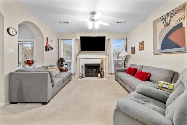 a living room with furniture fireplace and flat screen tv
