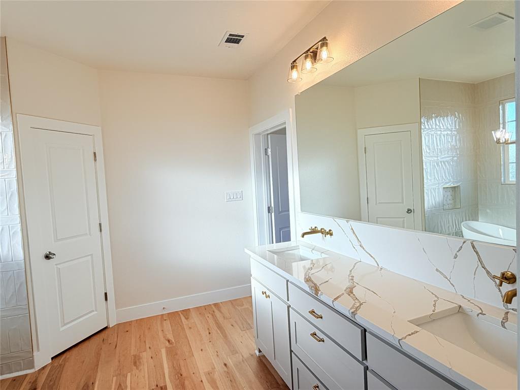 2780 Patrick Road Waxahachie, TX 75167 - Photo 11 of 20 a bathroom with a sink and a mirror