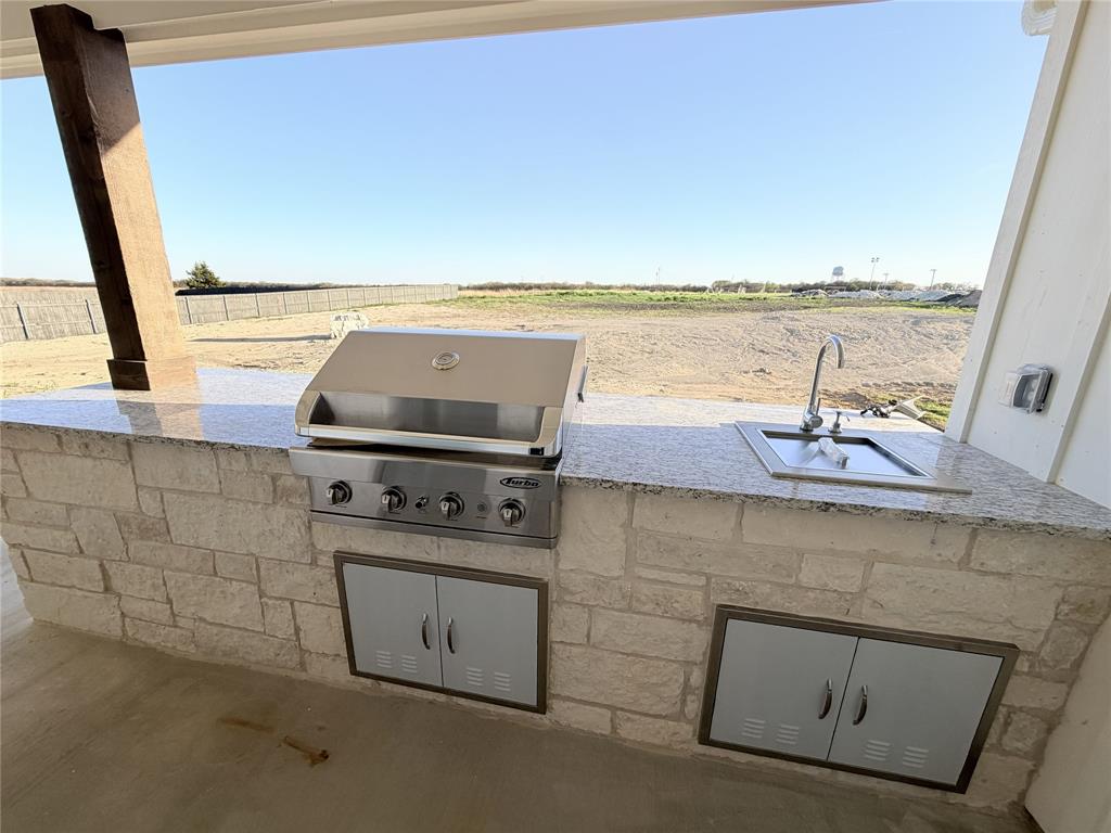 2780 Patrick Road Waxahachie, TX 75167 - Photo 20 of 20 a kitchen with a stove and a sink