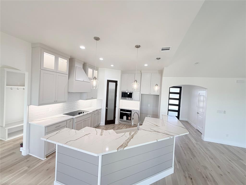 2780 Patrick Road Waxahachie, TX 75167 - Photo 2 of 20 a large white kitchen with a large counter top appliances and cabinets