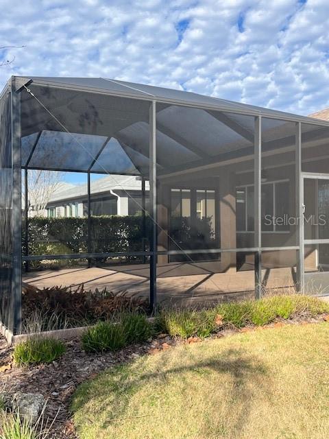 10584 Southwest 91st Street Road Ocala, FL 34481 - Photo 19 of 20 a view of a backyard with table and chairs under an umbrella