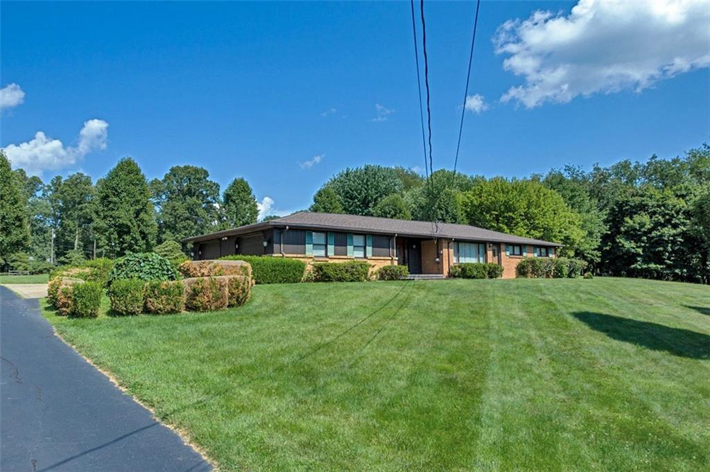 1702 Ridge Road Jeannette, PA 15644 - Photo 3 of 36 a front view of a house with garden