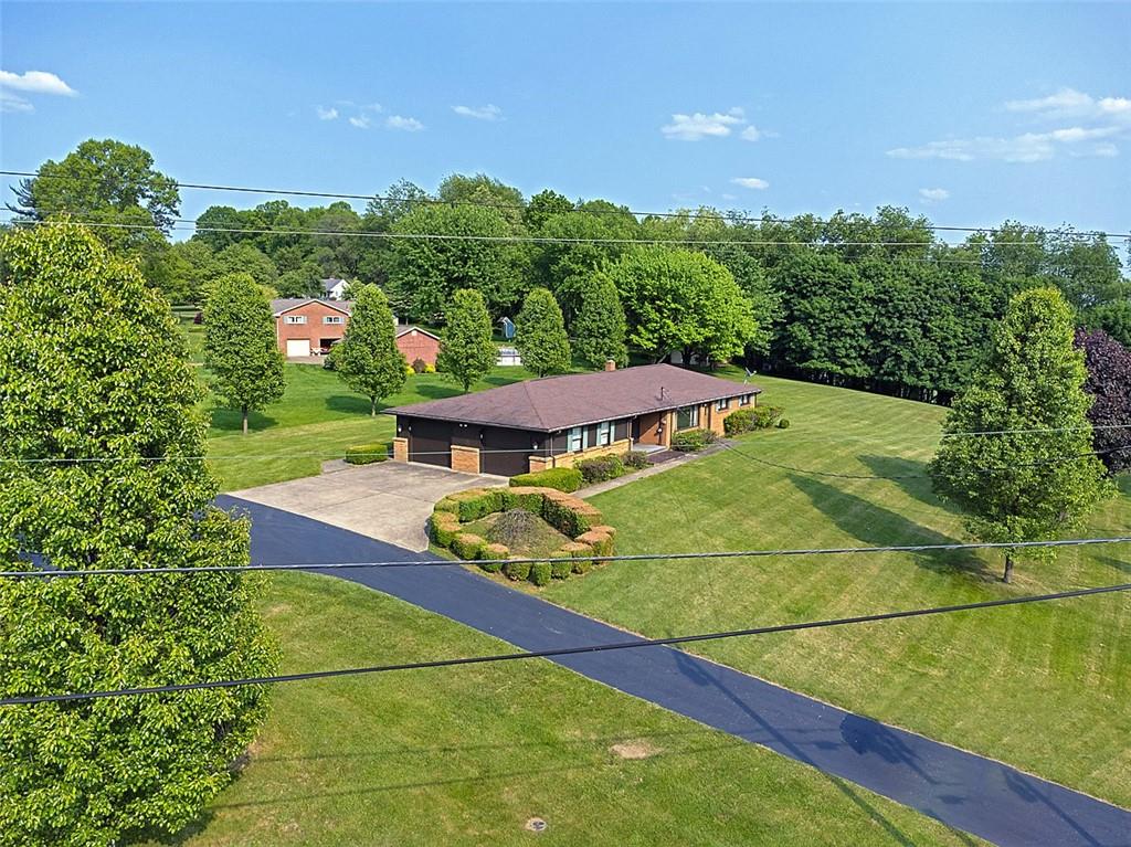 1702 Ridge Road Jeannette, PA 15644 - Photo 32 of 36 a view of a big yard with potted plants and large tree