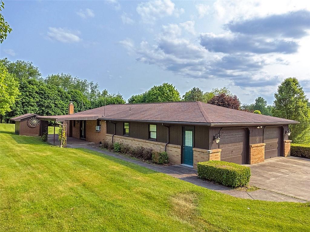 1702 Ridge Road Jeannette, PA 15644 - Photo 33 of 36 a front view of a house with a garden