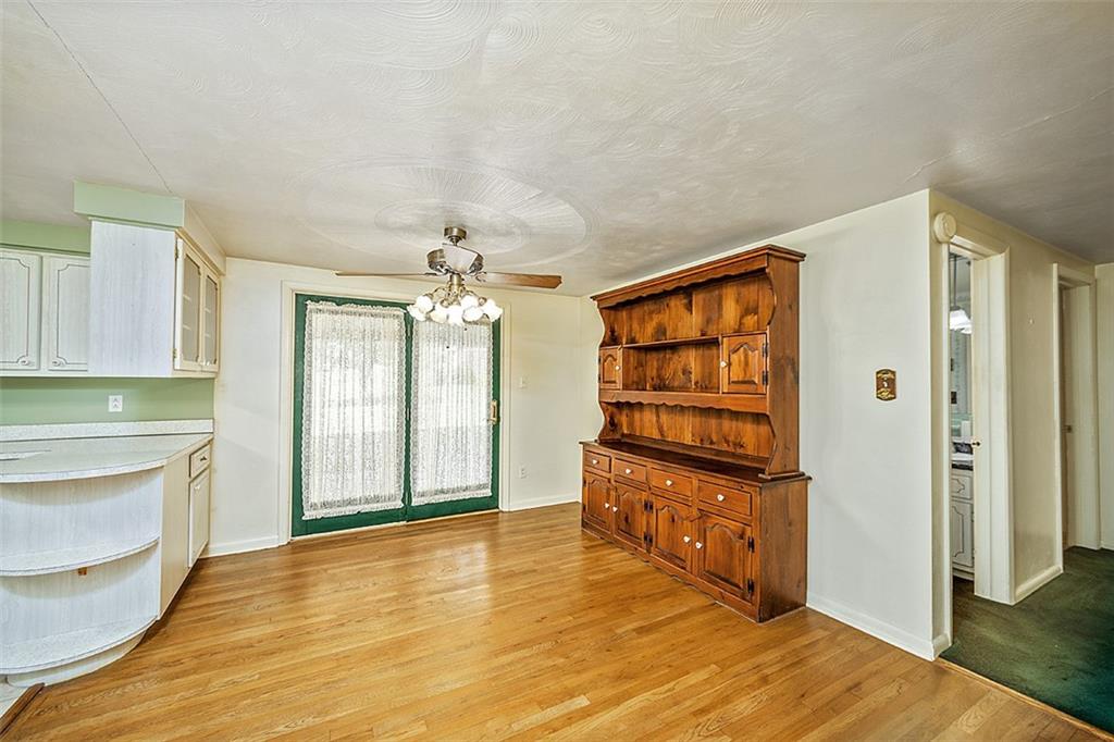 1702 Ridge Road Jeannette, PA 15644 - Photo 10 of 36 a view of an empty room with window and wooden floor