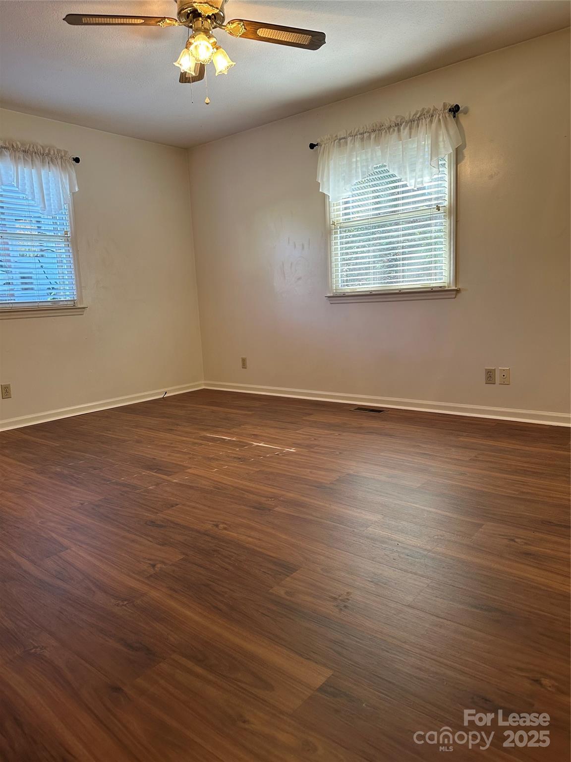 Undisclosed Address Hendersonville, NC 28792 - Photo 11 of 19 an empty room with wooden floor and windows