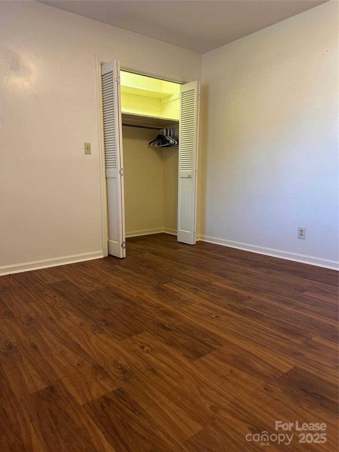 Undisclosed Address Hendersonville, NC 28792 - Photo 14 of 19 a view of an empty room with wooden floor and closet