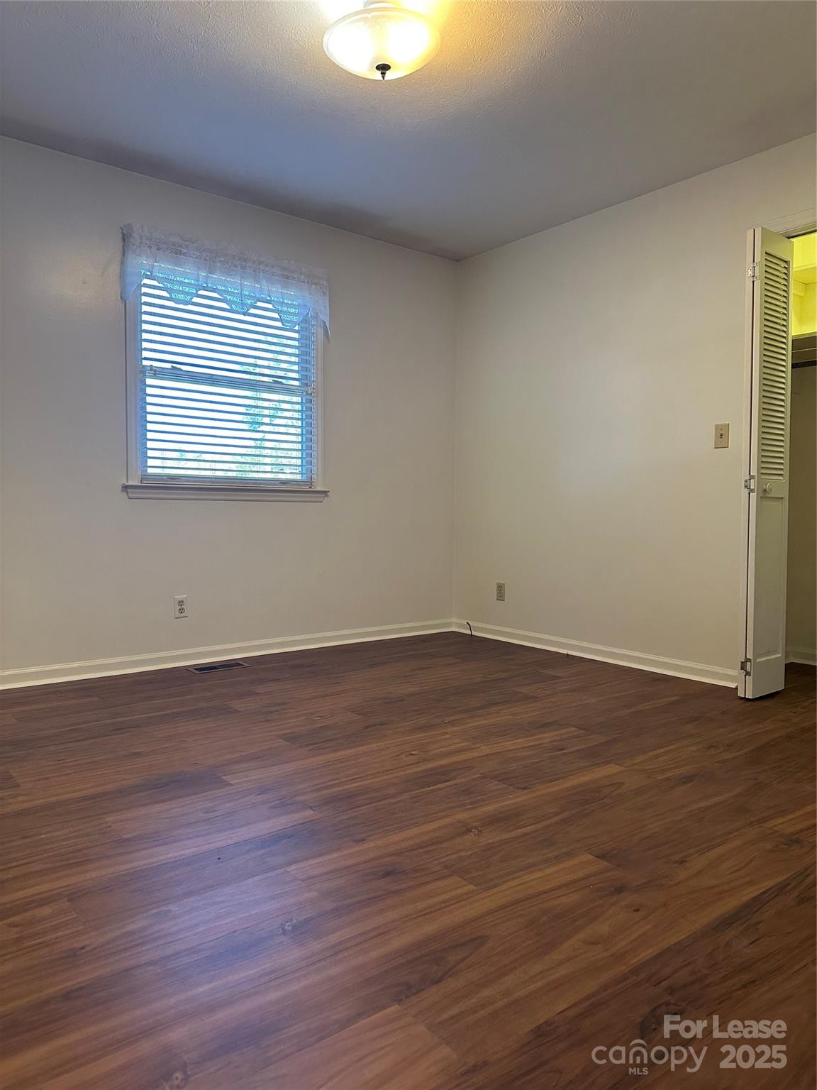Undisclosed Address Hendersonville, NC 28792 - Photo 16 of 19 an empty room with wooden floor and windows