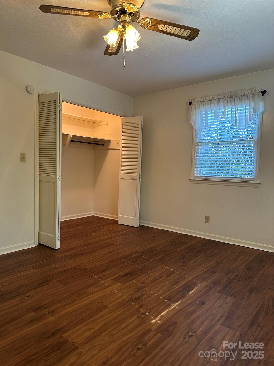 Undisclosed Address Hendersonville, NC 28792 - Photo 17 of 19 a view of an empty room with wooden floor and a window