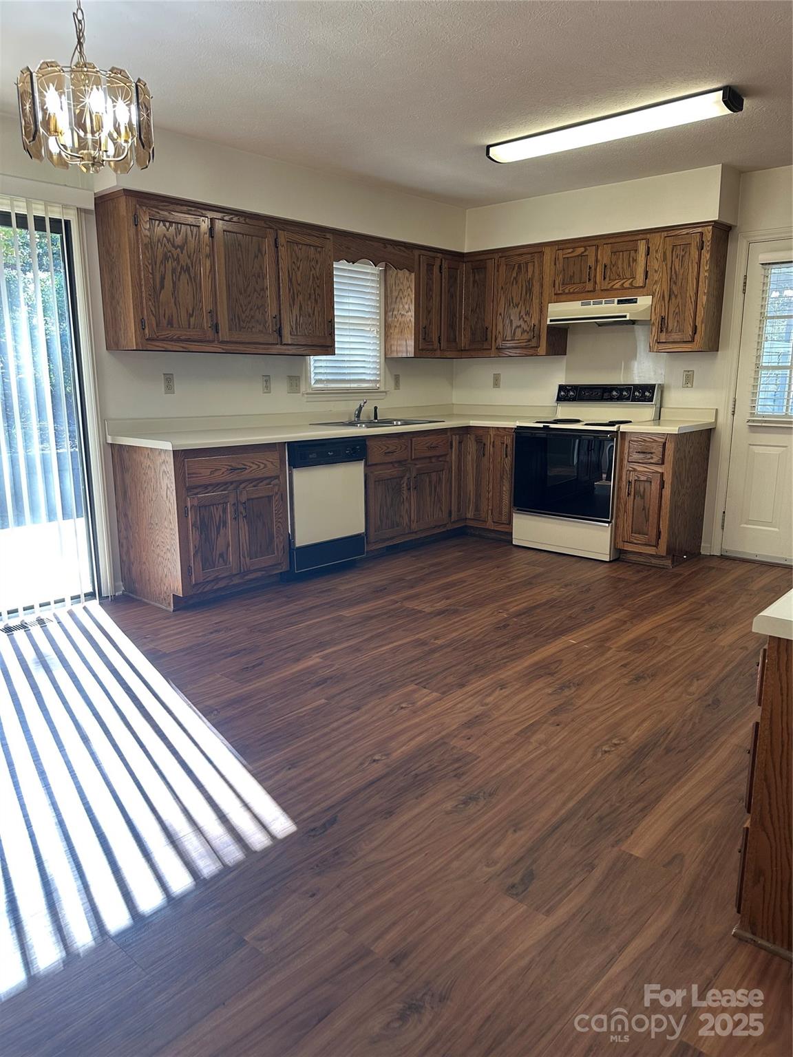 Undisclosed Address Hendersonville, NC 28792 - Photo 2 of 19 a kitchen with stainless steel appliances wooden floors and wooden cabinets