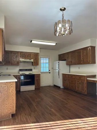 a kitchen with stainless steel appliances granite countertop a stove and cabinets