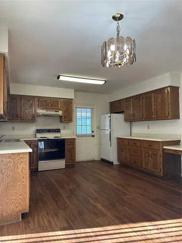 a kitchen with stainless steel appliances granite countertop a stove and cabinets