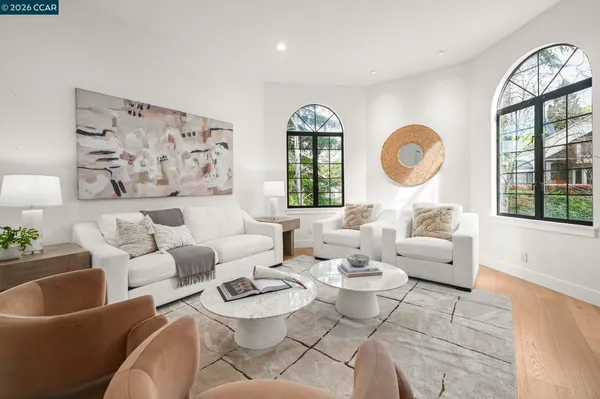 a living room with furniture large window and a flat screen tv
