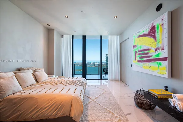 a bedroom with a bed and glass window