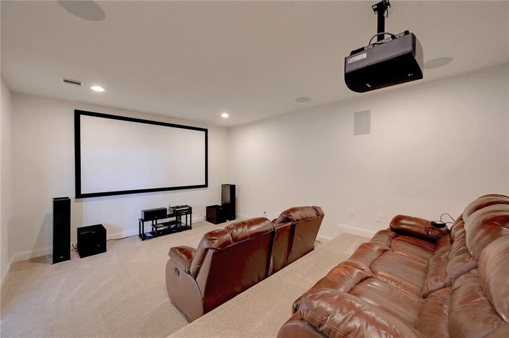 168 Raton Pass Dripping Springs, TX 78620 - Photo 18 of 20 Dedicated media room featuring a large projection screen, mounted ceiling projector, and recessed ceiling lighting