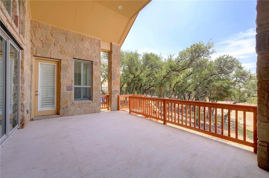 168 Raton Pass Dripping Springs, TX 78620 - Photo 20 of 20 Expansive outdoor patio featuring a concrete surface and a natural wood railing