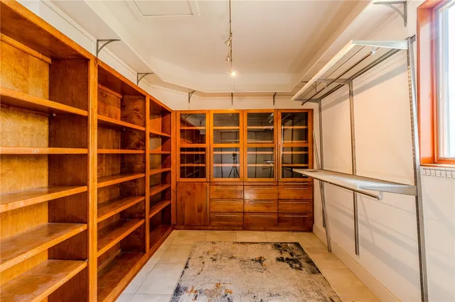a view of walk in closet with empty racks
