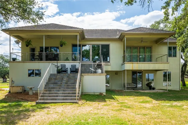 a view of a house with a swimming pool and porch
