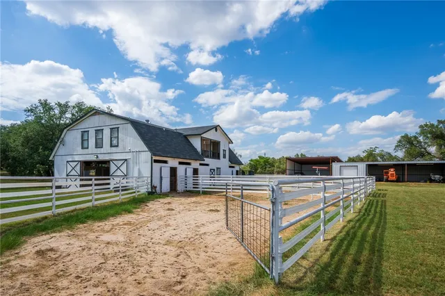 a view of house with outdoor space and sitting area